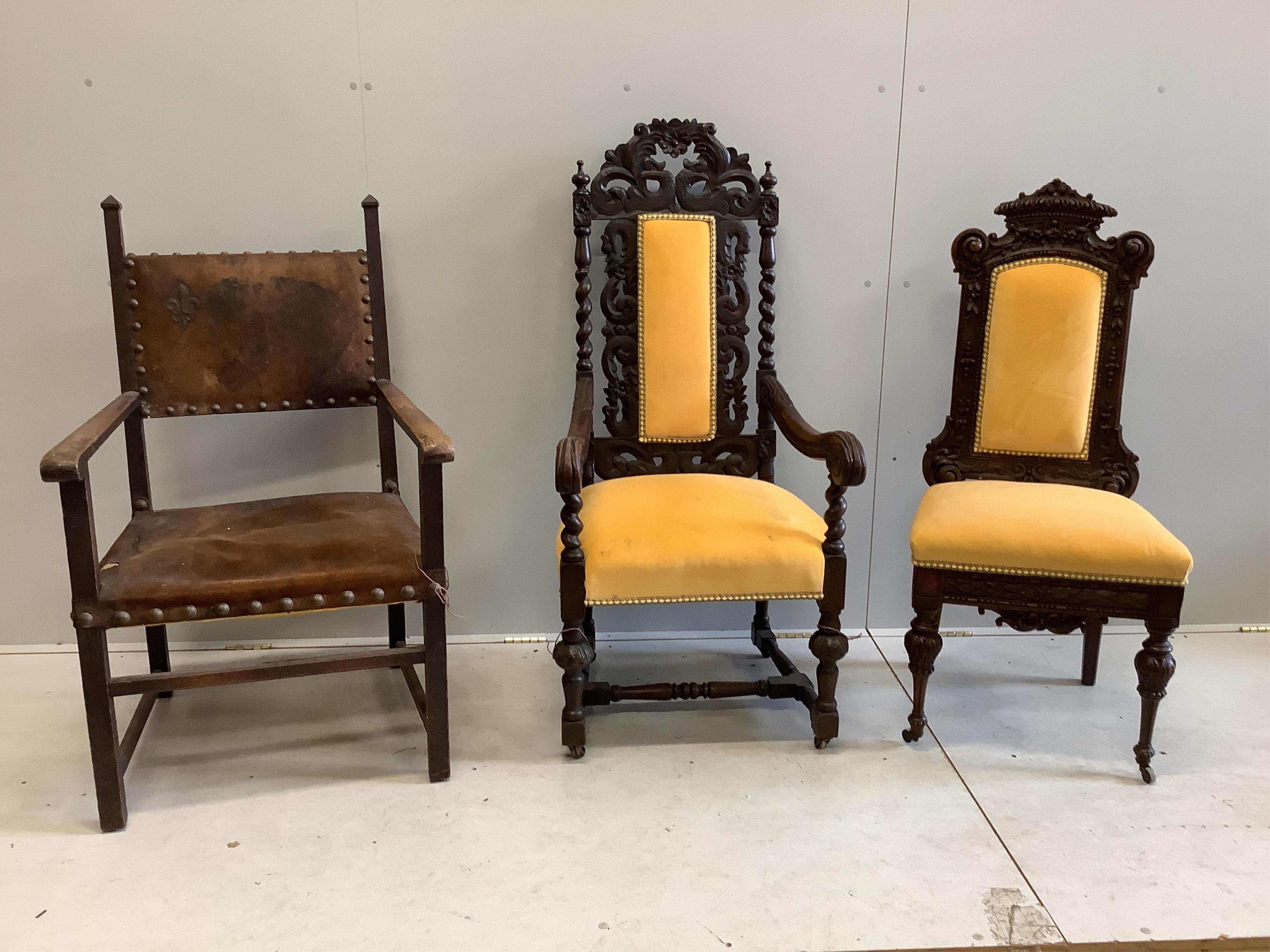 Two late 19th century Flemish carved oak dining chairs, one with arms, together with a Spanish style oak and leather elbow chair. Condition - fair to good